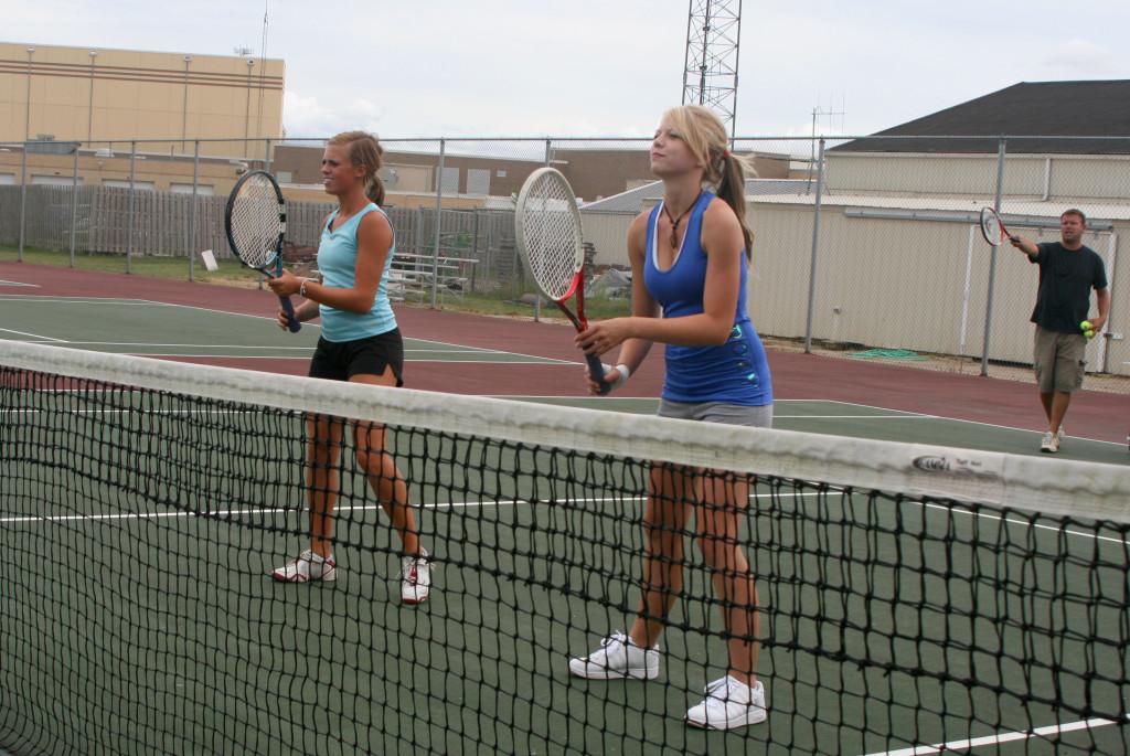 Senior Lindsay Jurcenko and junior Amelia Napiorkowski prepare for the Plainfield North tournament during practice.