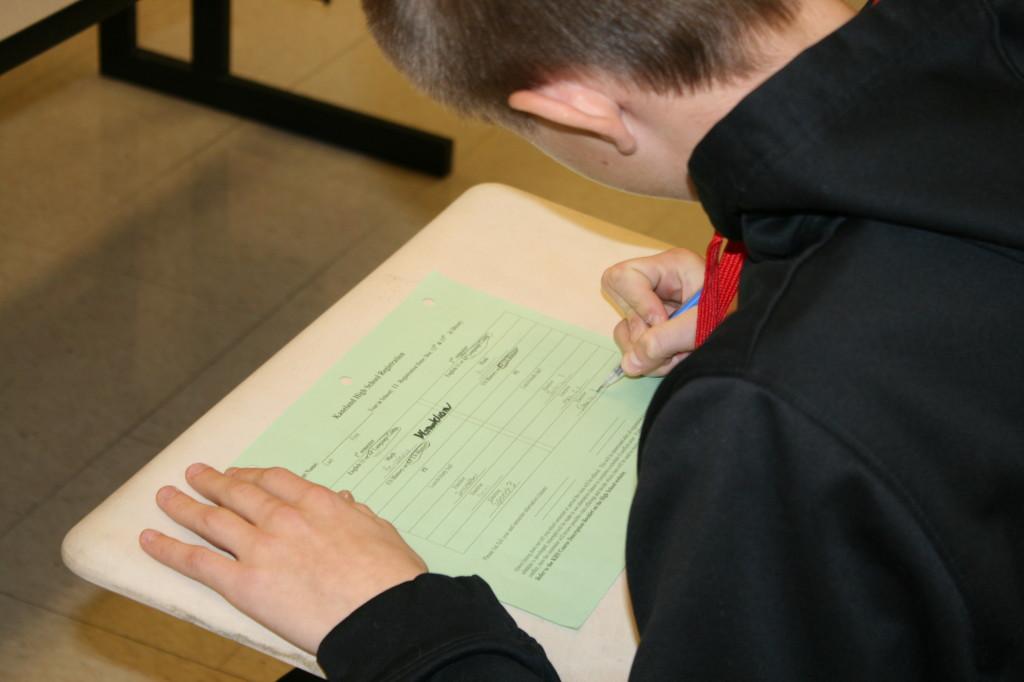 A student fills out his registration form.