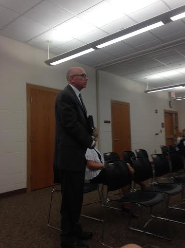 Dr. Ken Sorrick stands as the board members recognize his past accomplishments. 