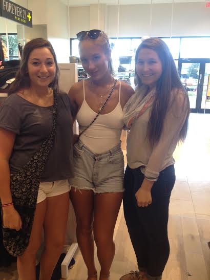 Seniors Gina Pettenon and Nicole McClellan pose with singer Niykee Heaton at the Forever 21 in Geneva Commons. 