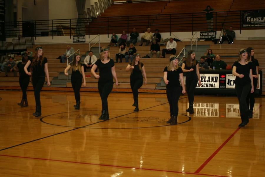 The Poms team performs a new military-style dance routine. 