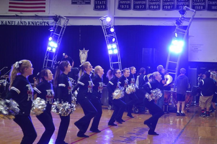 The pom team dances along side the marching band to pump up the crowd. 