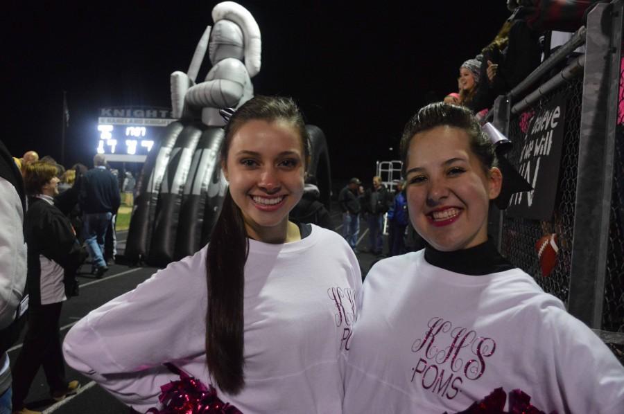Seniors Nicole Disandro and Aimee Frost get ready to take the field with the poms team. 