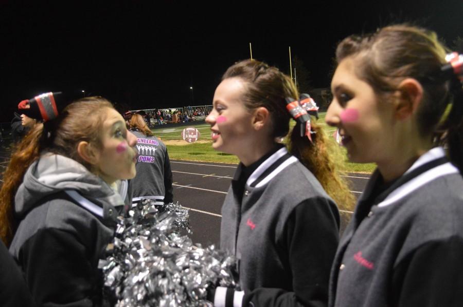 Poms team shows satisfaction with their performance. 