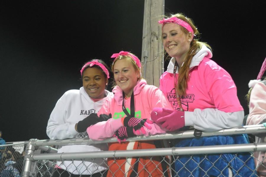 Seniors Lanita Vanderschaaf, Julia Schaefer and Madison Edwards sport pink out apparel. 
