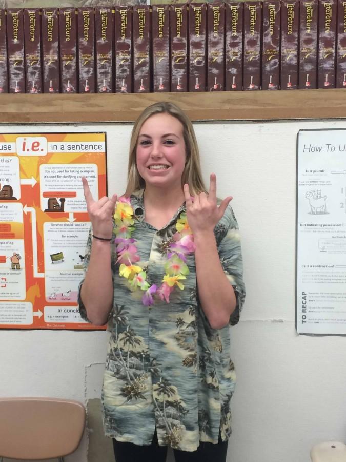 Freshman Hailey Roach shows she is ready for winter vacation by wearing leis and a short-sleeved floral shirt.