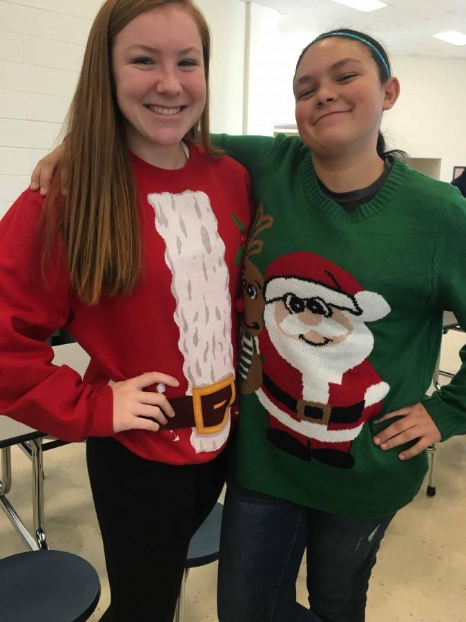 Sophomores Maddy Wheatley and Logan Guerra are photographed together wearing ugly Santa Christmas sweaters. 