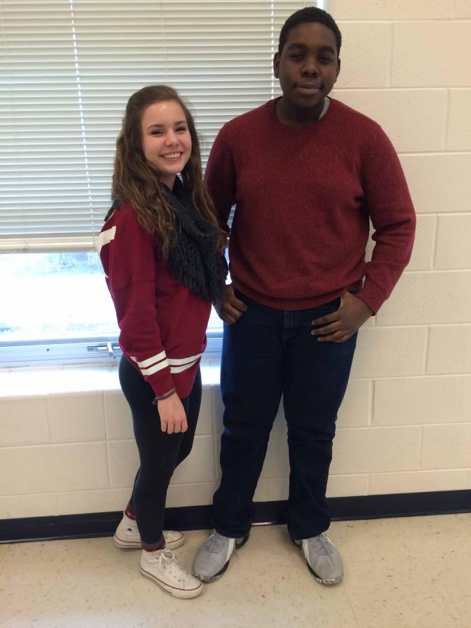 Freshman Lindsey Norman and Mobolaji Ayegbusi are decked out in maroon red during lunch on Tuesday.