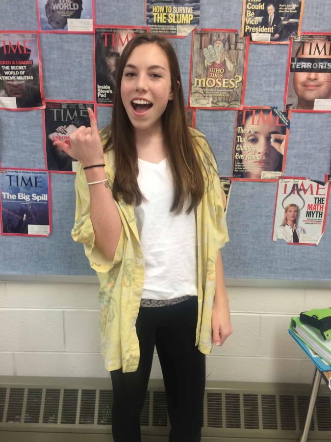 Sophomore Maggie Burger happily participates in spirit week by borrowing her dads shirt.



