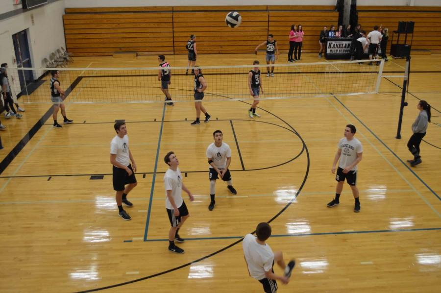 Boys scurry to keep the volley going. 