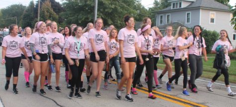 Senior Powder Puffs walk through Kaneville for the homecoming parade.