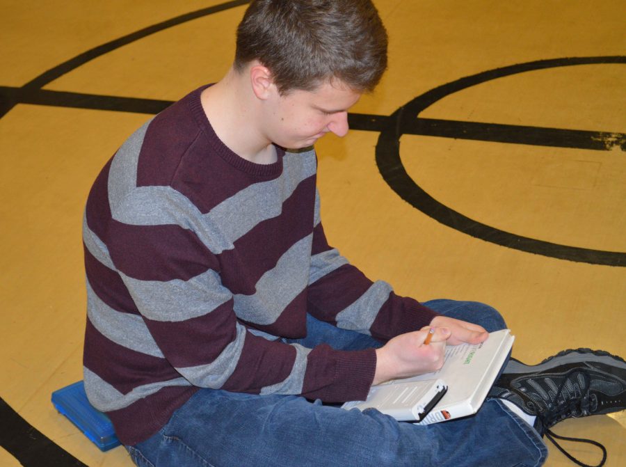 Students rush to do their homework while fulfilling physical education requirements.