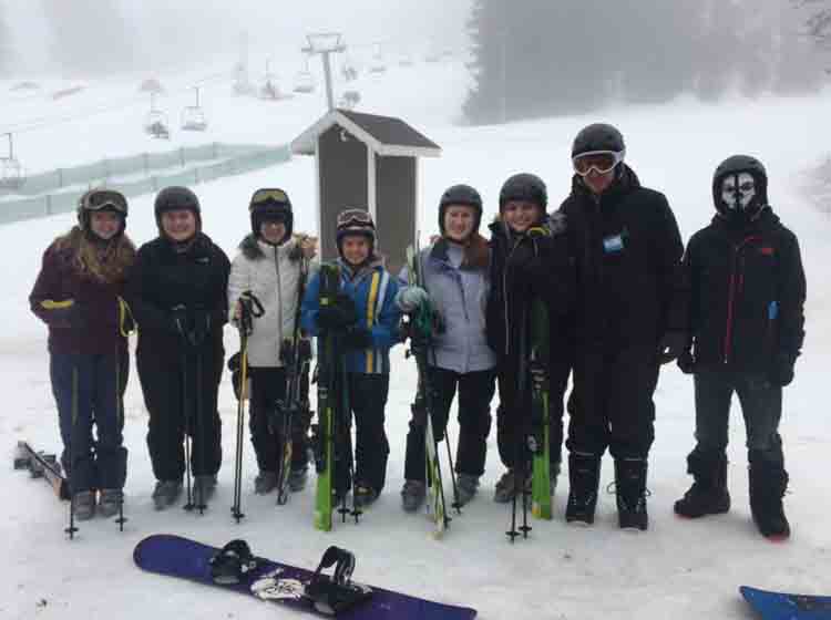 Emma Hockey, Julia Biard, Rachel Brazee, Andrea Wells, Katie Biard, Morgan Angelo, Joshua May and Brandon Albarron all prepare for ski school. The excitement came an hour and a half later when they took their skills to the slopes.