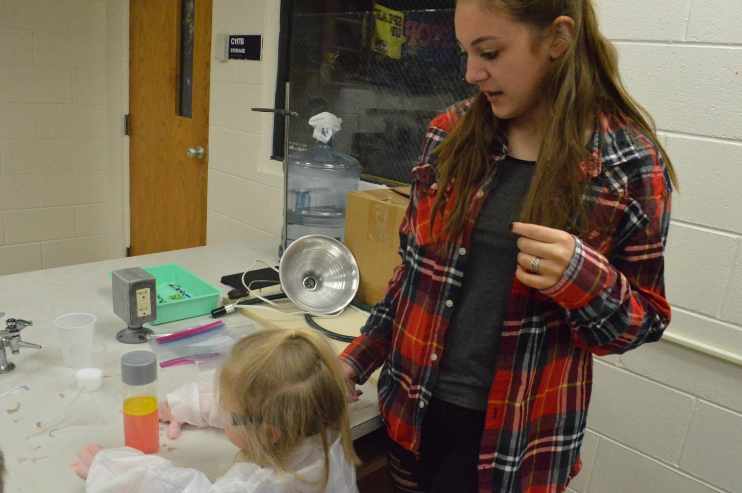 Junior Brooke Long and preschooler Morgan French wait for their solution to crystalize.