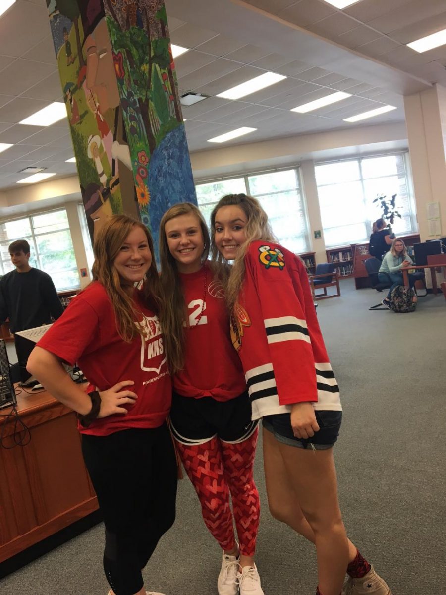 Juniors Maddie Wheatley, Miranda Watson and Grace Arnold deck out in red to show their class color.