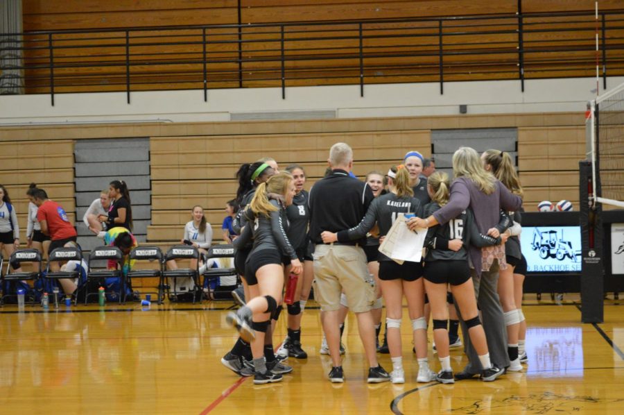 The volleyball team celebrates their regional victory at the end of the game.