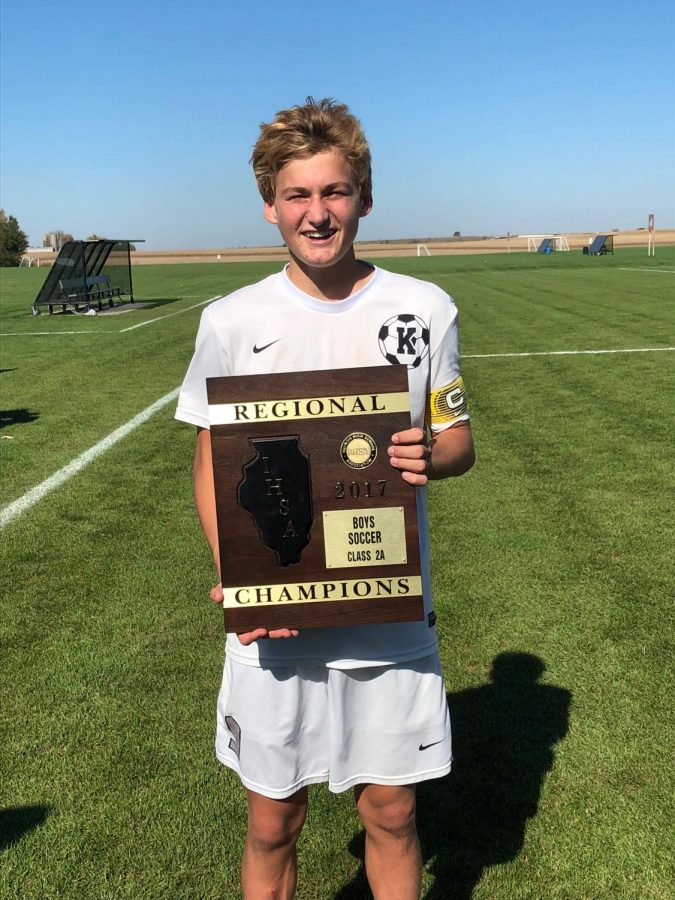 Bartholomew holds the regional champion plaque after their game went into penalty kicks. Photo courtesy of Dorcey Bartholomew.