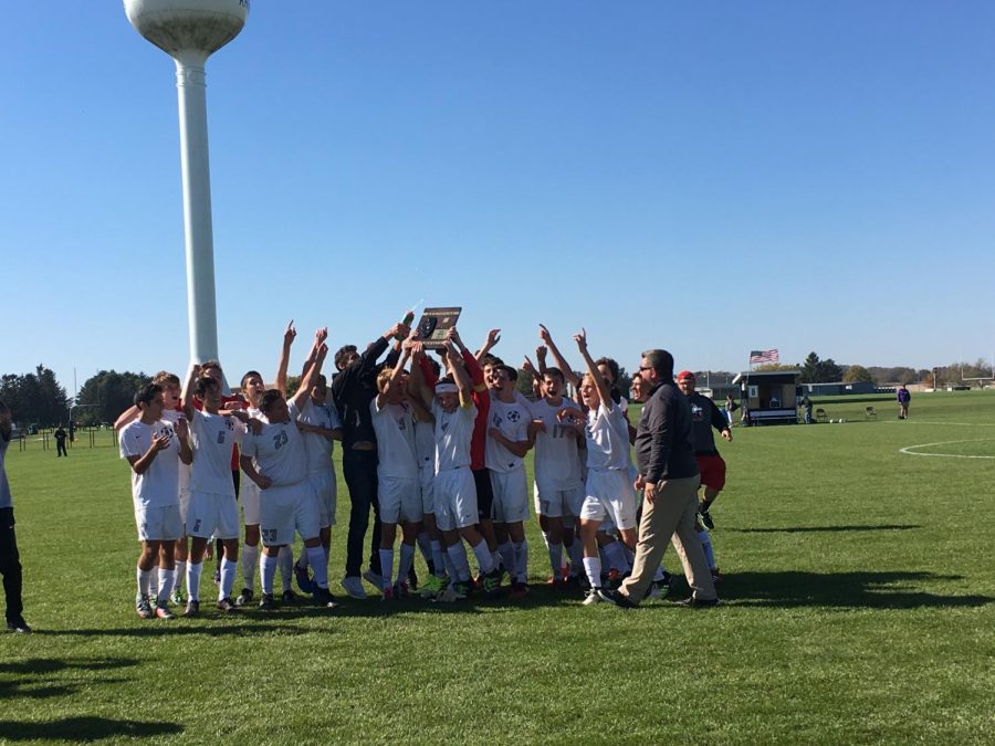 The boys varsity soccer team celebrates their victory after the game.