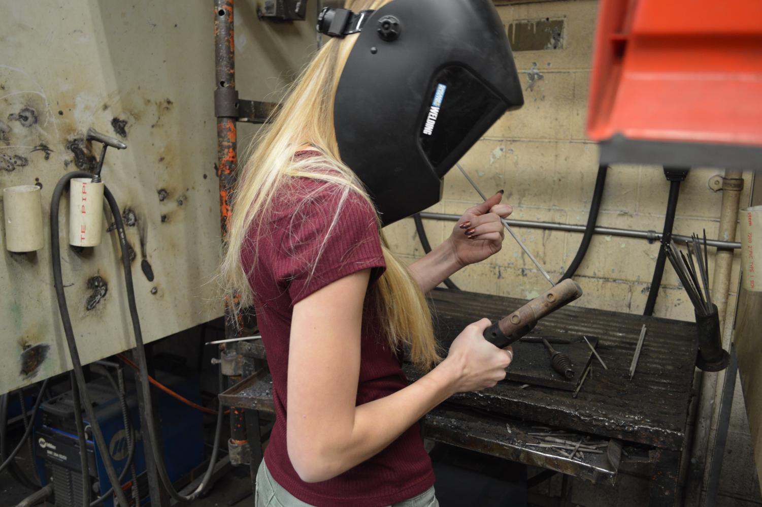 Junior Ashtyn Winkler prepares to weld.