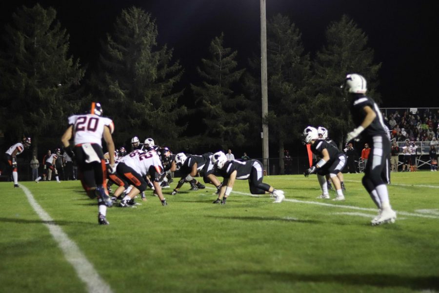 A DeKalb receiver starts in motion while the Kaneland defense awaits the snap.