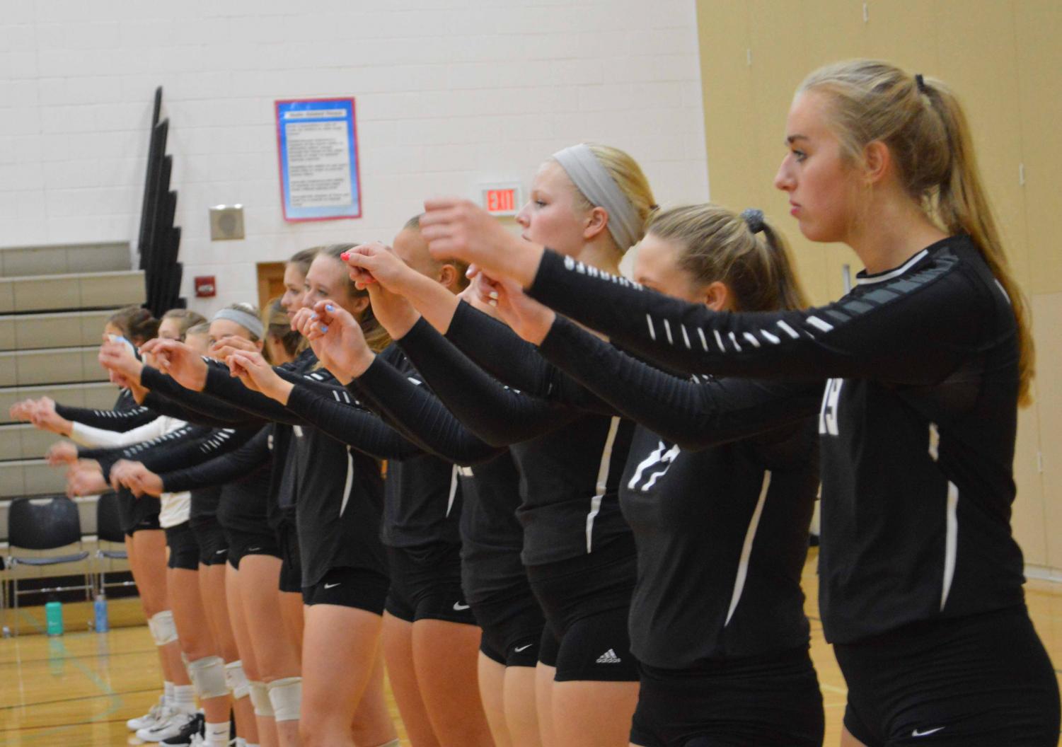 The Kaneland varsity volleyball team lines up for their game.