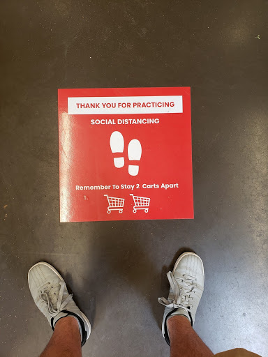 Customers stand by stickers on the floor to remind and thank them for following social distancing guidelines.On March 15, the Center for Disease Control released a statement telling everyone to follow social distancing. 
