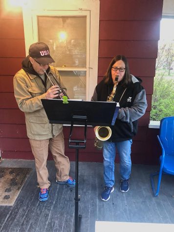 Phil Hardin (left) and Patty Sampson (right) play together on Sampson's porch. They enjoy working together to raise money for charity.