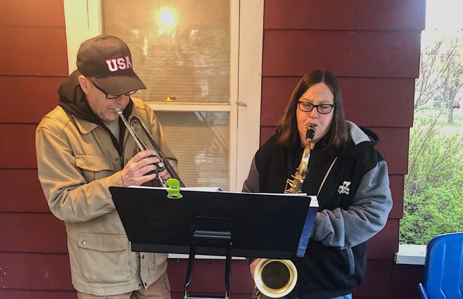 Phil Hardin (left) and Patty Sampson (right) play together on Sampsons porch. They enjoy working together to raise money for charity.