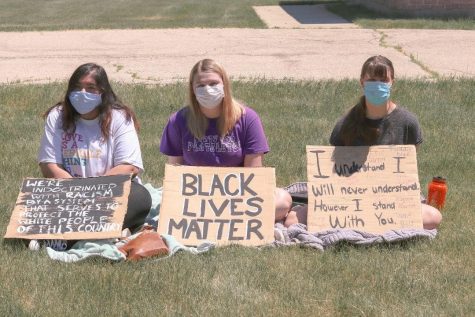 Community members at the peaceful assembly at Elburn's Village Hall hold signs in support of the Black Lives Matter movement. Throughout America, people have come together to demonstrate their commitment to ending systemic injustice towards and mistreatment of Black people.