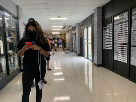 Students wait in line near the main office of Kaneland High School for parking passes. Monday's board meeting focused on updating the details on what is sure to be a different school year for everyone.