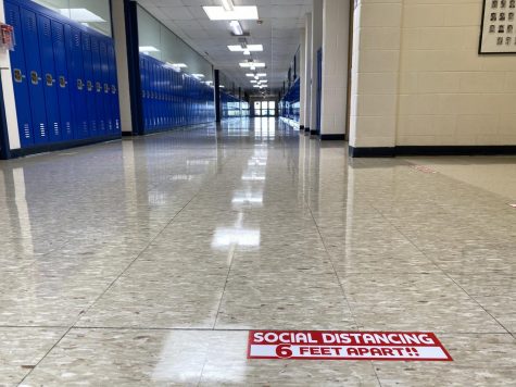 Social distancing signs have been placed throughout Kaneland High School in advance of students' first in-person day of Thursday, August 20. A typically crowded hallway stands empty now, but will look different next week.