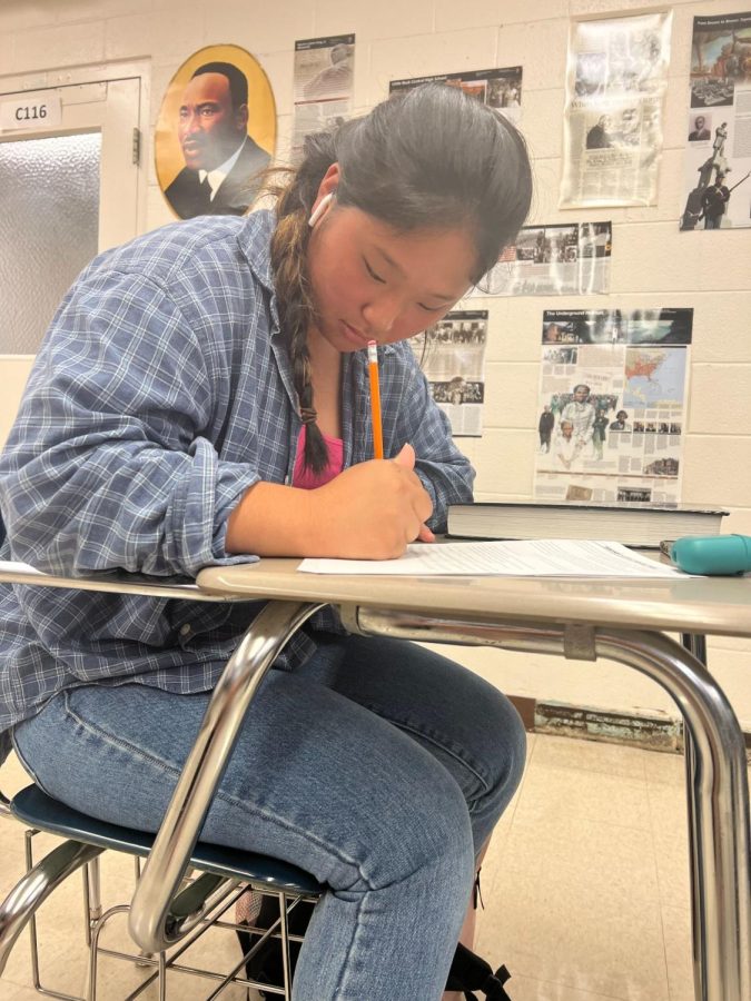 Junior Aeryn Hwang works on her AP U.S. history assignment. She worked hard in order to turn in the assignment by the end of the class period.