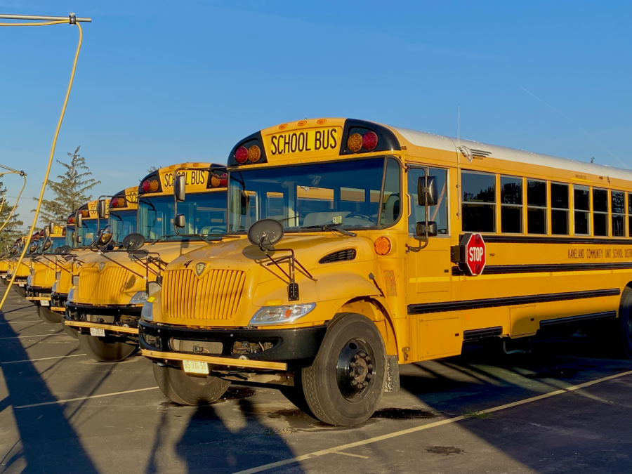 Numerous buses are parked in the Kaneland bus parking lot, while others are out on routes picking up students. Currently, Kaneland has more buses than bus drivers available. 