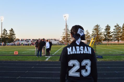 Senior Amelia Marsan looks out onto the football field during senior night on Friday, Oct. 21. Marsan has been cheering for Kaneland since elementary school. 