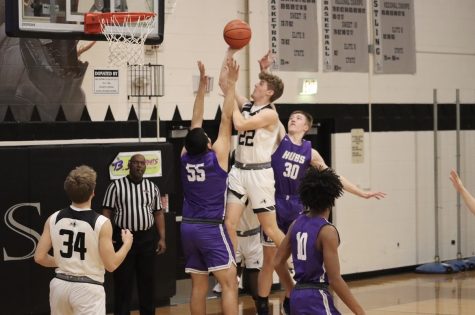 Senior guard Johnny Spallasso attacks the basket during the first quarter of a January home conference game against Rochelle. Kaneland defeated the Hubs 86-64, with Spallasso adding 15 points.