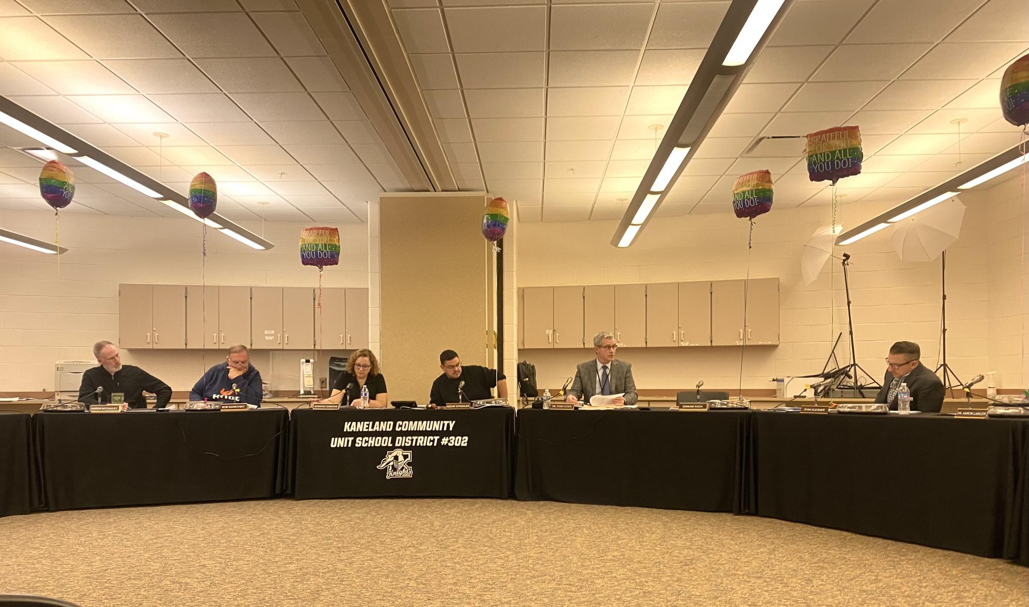 Members of the school board listen to Director of Educational Services 6-12 Patrick Raleigh present the proposed Kaneland High School course book for the 2024-25 school year. It included changes in course names, required graduation credits and new classes.