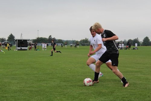 Kaneland senior forward/midfielder Sam Keen dribbles while a Sycamore player tries to defend him. Keen scored the only goal for Kaneland during regular time.