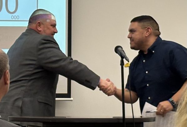 Future Superintendent Dr. Kurt Rohlwing shakes hands with Board President Addam Gonzales. Rohlwing will take over in his new role after current Superintendent Dr. Todd Leden’s planned retirement in 2025. 