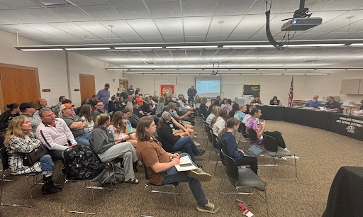 Current and past coaches and members of the Kaneland High School track team, parents of track athletes, and members of various news outlets sit in the audience at the April 29 board meeting. The board approved the total replacement of the track 7-0.