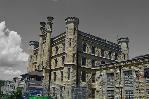 When I chose to take a tour of the Old Joliet Prison in Joliet, IL, I had no idea what I was walking into. I’ve heard of multiple paranormal events happening here, but I was more interested in how a prisoner lived. I wanted to feel their hopelessness and wanted to understand what it must have been like to sit in an empty cell and yearn for sunlight.
The Old Joliet Prison is a daunting structure that appears, seemingly, out of nowhere. When driving to the prison, it isn’t until someone is a few feet away that they see the large walls and barbed wire. Just driving past it, they can feel a change in the atmosphere.
When a prisoner is being driven there, they don’t know how close they are. They are driving through a suburban neighborhood before they reach a small unassuming bridge. Yet, as soon as they go under the bridge and back into the sunlight, they finally see the prison and know that as soon as they go in, they will never come out.
“In 1878, the Prison was filled well over capacity with nearly 2,000 inmates,” according to jolietprison.org, a website that tells the history of the prison and allows for you to sign up for tours. “[There were] reports of unsanitary and dangerous conditions emerged.”
Throughout the state, people knew the allegations that staff was abusing the prisoners as well as killing them. Once a prisoner was told that they were going to Old Joliet Prison, they knew that it was a death sentence