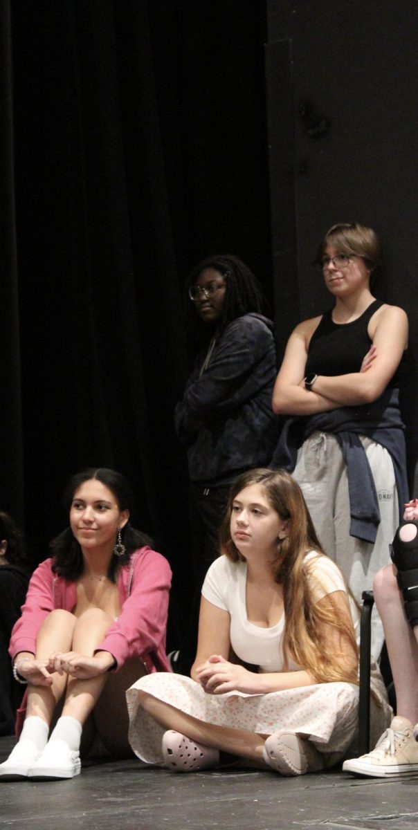 Senior Sydney Pflipsen, juniors Iyvanka-Isis Ewane-Ewang and Laura Batts and sophomore Charlie Placzek watch their fellow actors audition for the fall play. Groups of three or four students audition for the play in front of their peers. 