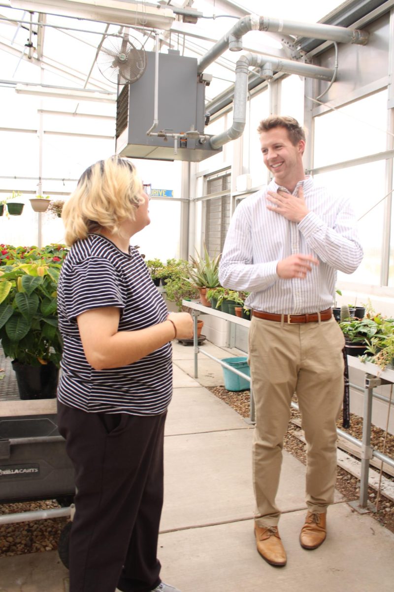 FFA advisers Bradley Lorenz and Adrian Hernandez talk in the KHS greenhouse. This is both of the teachers' first years advising Kaneland FFA.