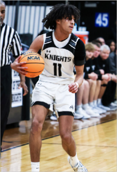 Junior Evan Frieders plays in a varsity basketball game against Sycamore High School. Frieders played with a partially torn labrum throughout the season in order to delay surgery. 