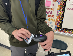 Kaneland High School sophomore Caden Rosinski scans his ID. The program connected to the scanner scans his ID and signs him out of his current class.