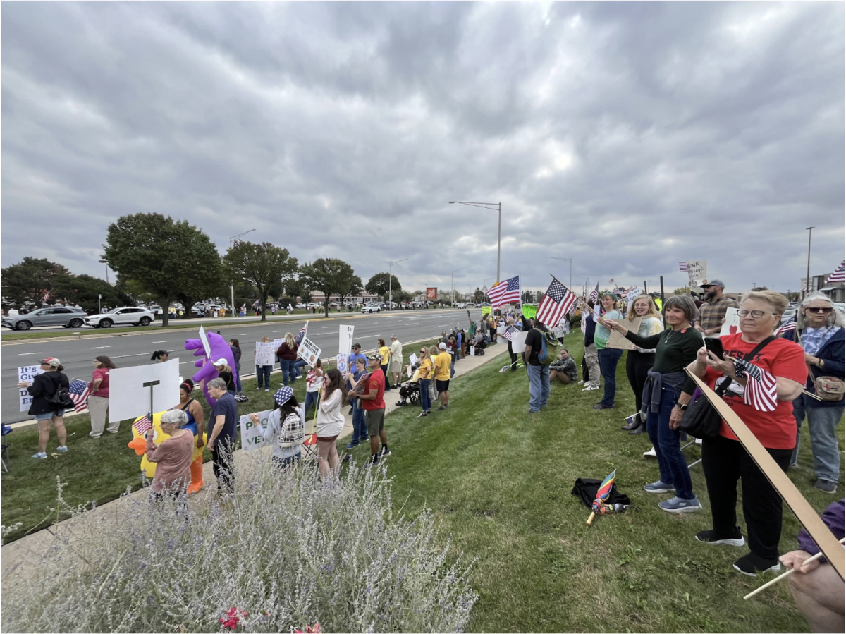 Local protestors gather on Randall Rd. in Geneva, IL, in favor of the No Kings protests. These protests stretched across the U.S., gathering nearly 7 million individuals, becoming one of the largest in U.S. history.