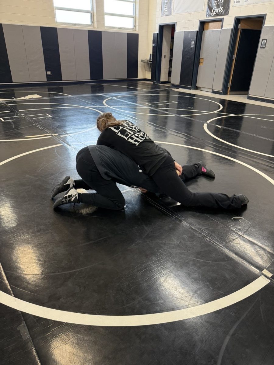 Sophmores Reygan Behrends and Bella Gruber wrestle at practice. Their next meet is on Jan. 16, at Northern Illinois University.