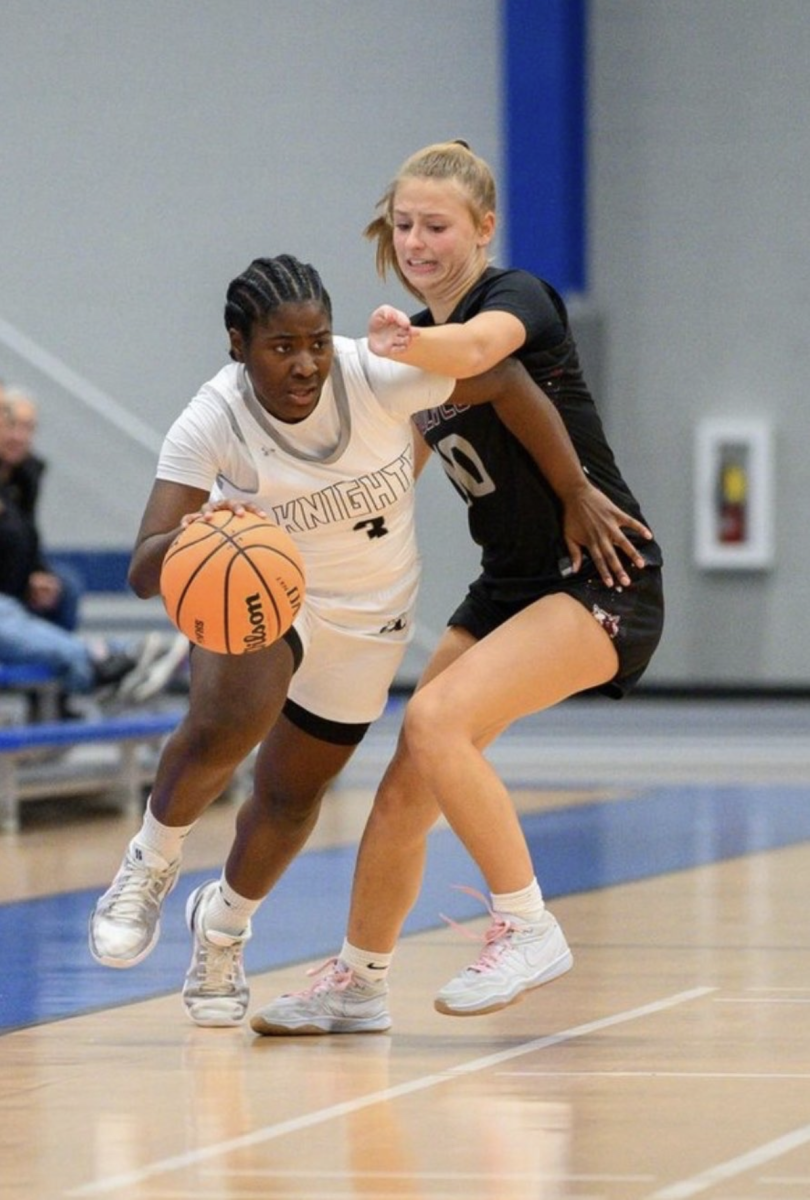 Junior Amani Meeks drives past her defender. Meeks scored 8 points as the Knights defeated Prairie Ridge 
by a final score of 49-26 on November 18, 2025.
