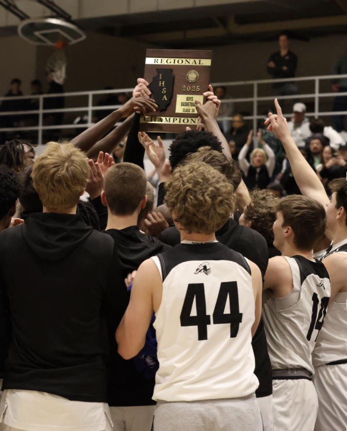 Players from the 2024-25 team (32-2) celebrate their 66-56 Regional championship win over Wheaton Academy. The Knights went on to defeat Crystal Lake South 49-37 to win their Sectional championship before losing to Depaul College Prep in the Supersectional round. 