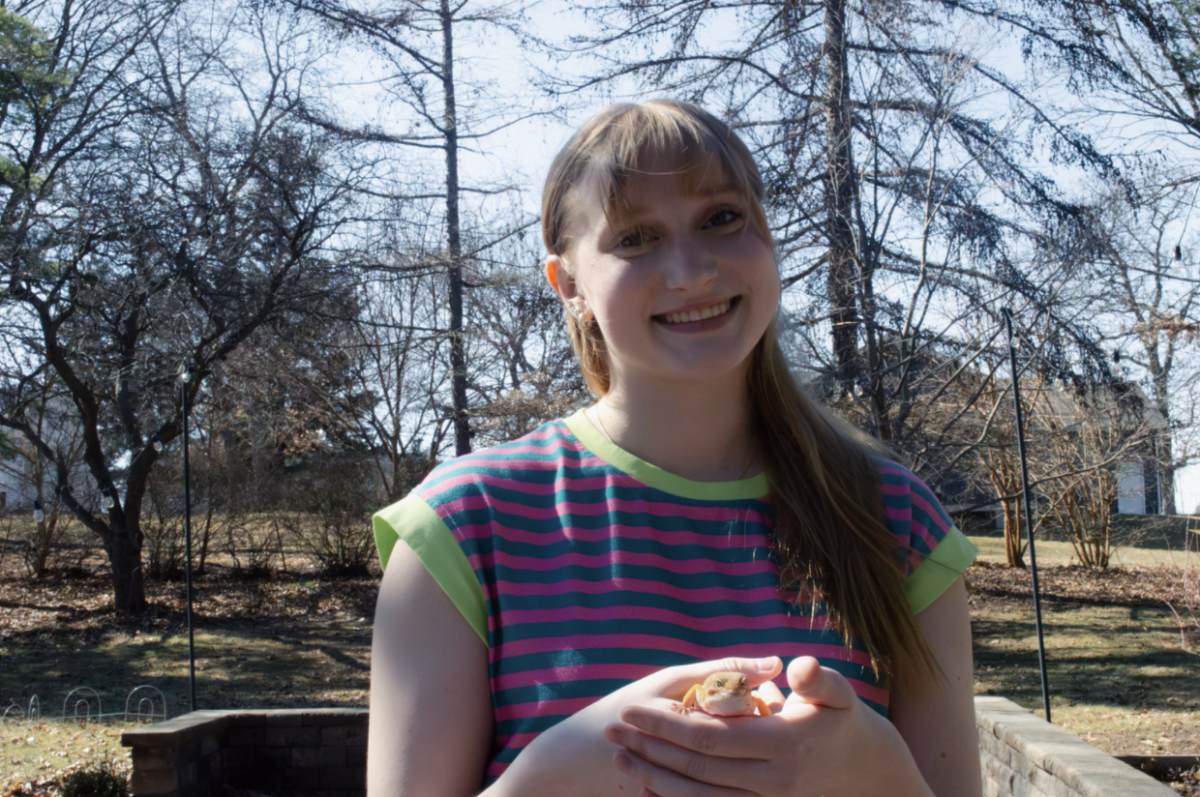 In her backyard, junior Haley Swim holds her  leopard gecko, Kringle. Swim received Kringle three years ago as a Christmas present after her old gecko passed away that same year. Kringle often sits on Swim’s shoulder as a loyal companion.